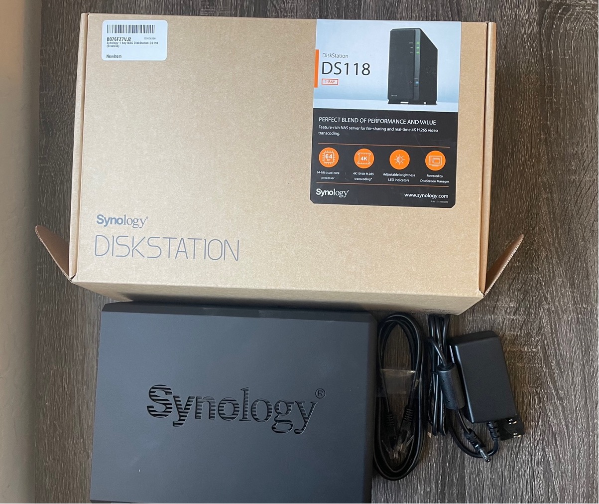 A Synology one-bay DS118 NAS device and its box.